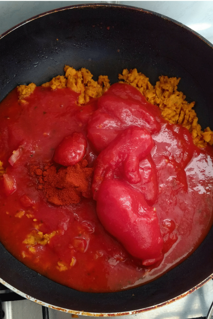 sweet potato on a frying pan with canned tomatoes and seasonings tomato sauce2